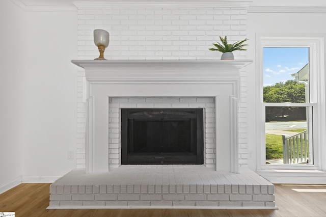 103 Gaithburg Sq, Taylors, SC 29687 - detailed view of wood finished floors, ornamental molding, and a brick fireplace