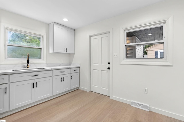 2318 S Mcduffie St, Anderson, SC 29624 - kitchen with light wood-type flooring, healthy amount of natural light, white cabinets, and recessed lighting
