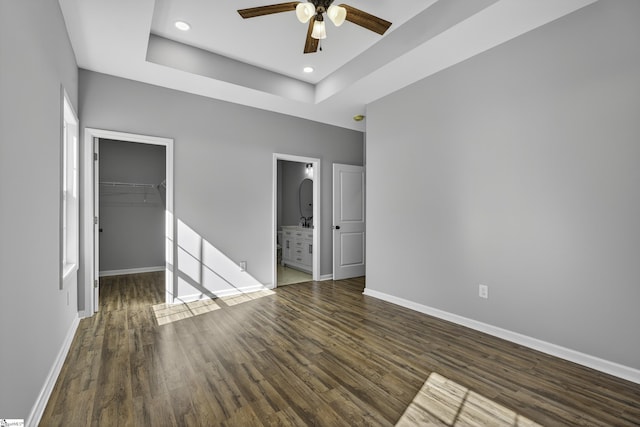 107 Toney Creek Rd, Belton, SC 29627 - unfurnished bedroom featuring a spacious closet, wood finished floors, a closet, a tray ceiling, and ensuite bathroom