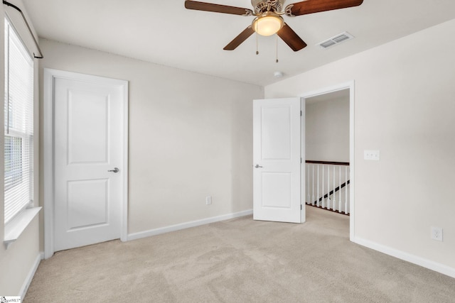 10 Wiltshire Cir, Easley, SC 29642 - unfurnished bedroom featuring light colored carpet, multiple windows, and ceiling fan