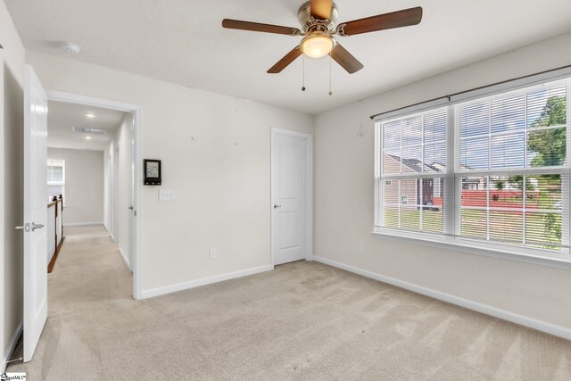 10 Wiltshire Cir, Easley, SC 29642 - empty room featuring light colored carpet, a smoke detector, and plenty of natural light