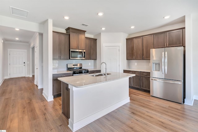 6 Shorncliffe Rd, Simpsonville, SC 29680 - kitchen with appliances with stainless steel finishes, light wood-type flooring, dark brown cabinetry, tasteful backsplash, and recessed lighting