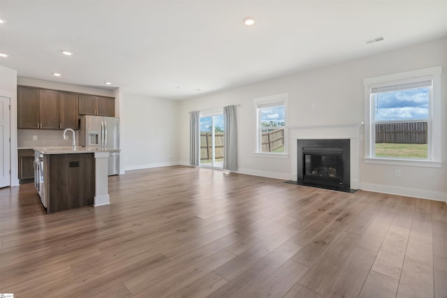 6 Shorncliffe Rd, Simpsonville, SC 29680 - unfurnished living room featuring recessed lighting, light wood finished floors, and a fireplace with flush hearth