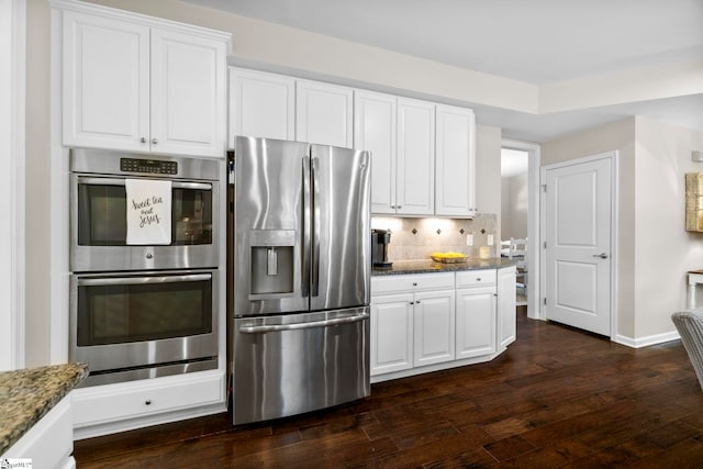 202 Princeton Dr, Duncan, SC 29334 - kitchen featuring stainless steel appliances, dark wood-style floors, white cabinetry, dark stone counters, and backsplash