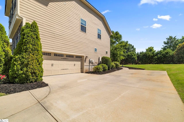 202 Princeton Dr, Duncan, SC 29334 - view of side of property with concrete driveway, an attached garage, and a lawn