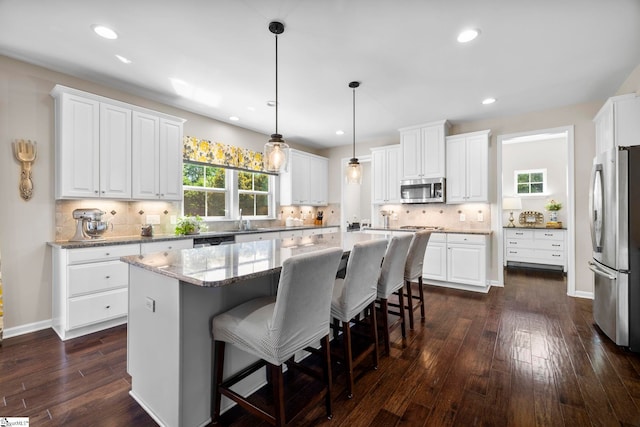 202 Princeton Dr, Duncan, SC 29334 - kitchen featuring appliances with stainless steel finishes, dark wood finished floors, a center island, white cabinetry, and recessed lighting