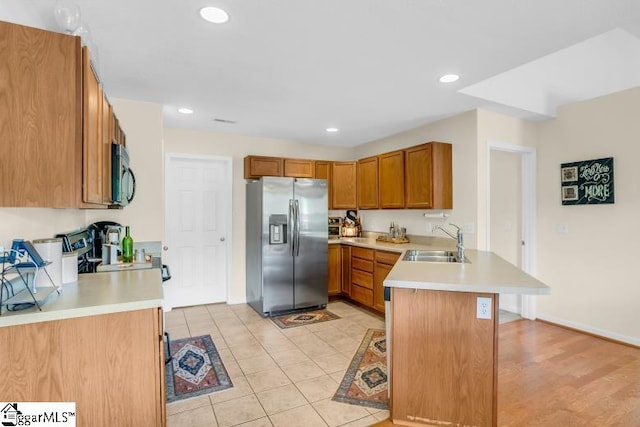 431 Lynnell Way, Moore, SC 29369 - kitchen with appliances with stainless steel finishes, a peninsula, light countertops, brown cabinets, and recessed lighting