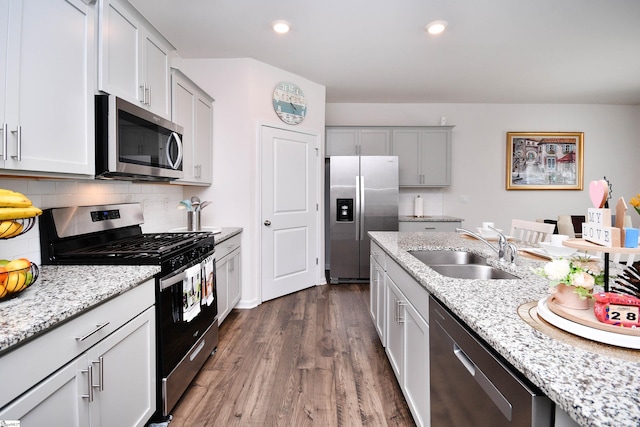 805 Colmore Trl, Lyman, SC 29365 - kitchen with appliances with stainless steel finishes, dark wood-style floors, decorative backsplash, light stone countertops, and recessed lighting