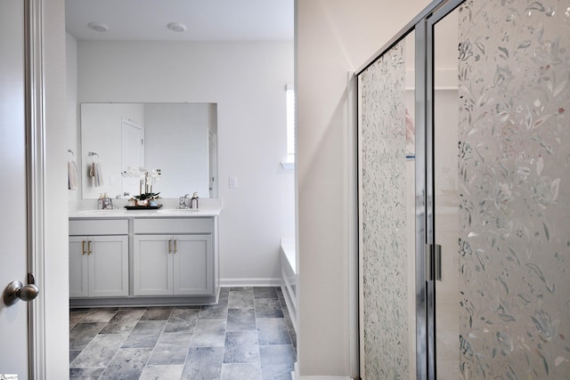 805 Colmore Trl, Lyman, SC 29365 - bathroom featuring double vanity, a shower stall, a bath, and stone finish flooring