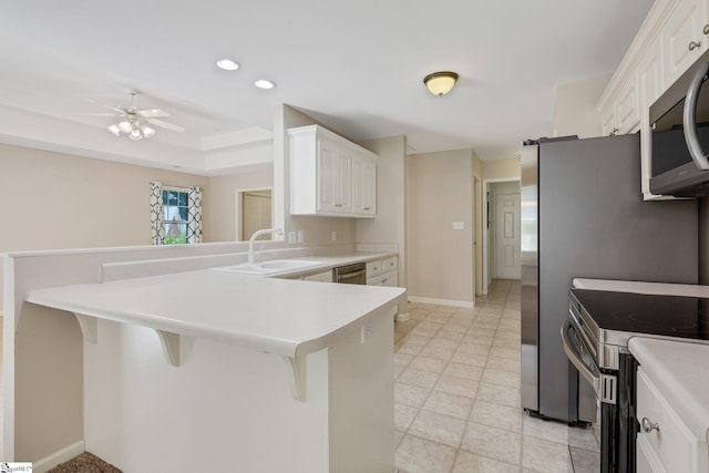 415 N Pond View Dr, Duncan, SC 29334 - kitchen featuring appliances with stainless steel finishes, a kitchen breakfast bar, a peninsula, white cabinetry, and light countertops