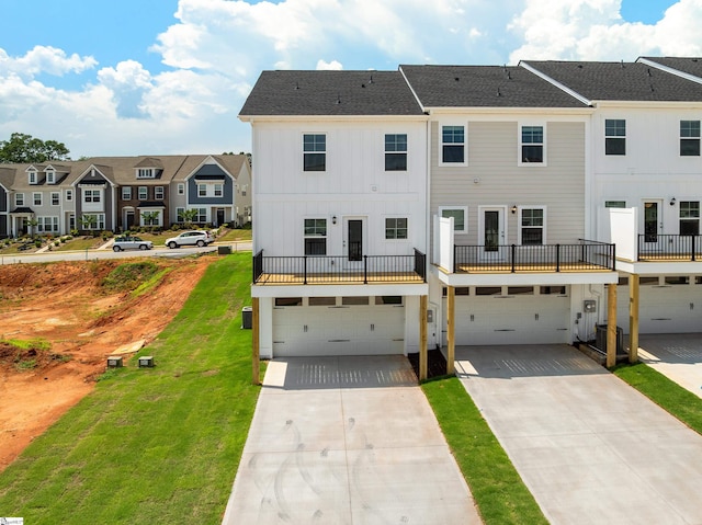 41 Leander Dr, Greer, SC 29651 - rear view of house with board and batten siding, an attached garage, a residential view, driveway, and a lawn