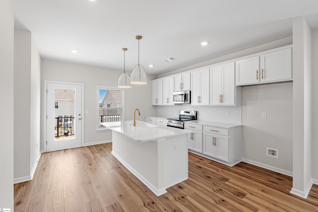 41 Leander Dr, Greer, SC 29651 - kitchen with stainless steel appliances, light wood-style floors, white cabinets, and recessed lighting