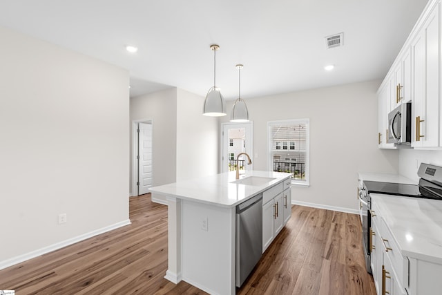 41 Leander Dr, Greer, SC 29651 - kitchen with stainless steel appliances, light wood-style floors, a center island with sink, white cabinetry, and light countertops