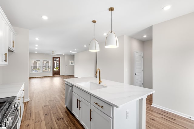 41 Leander Dr, Greer, SC 29651 - kitchen with stainless steel appliances, light wood-style flooring, white cabinetry, a kitchen island with sink, and ceiling fan