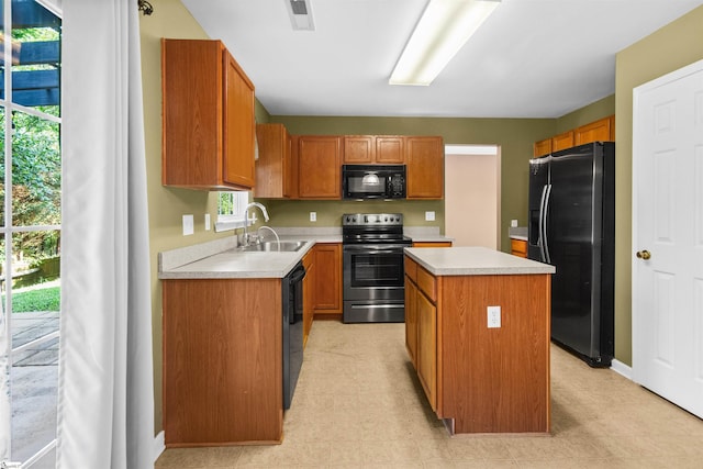 118 Moonshadow Ct, Duncan, SC 29334 - kitchen featuring black appliances, a center island, light countertops, and brown cabinetry
