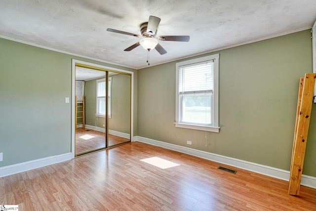 160 Bill Roberson Rd, Enoree, SC 29335 - unfurnished bedroom with wood finished floors, ornamental molding, a closet, and ceiling fan