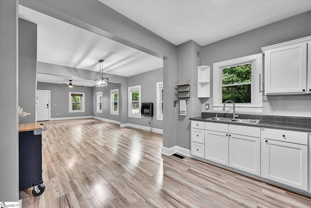 23 Stringer St, Belton, SC 29627 - kitchen with a textured ceiling, open floor plan, healthy amount of natural light, decorative backsplash, and light wood finished floors