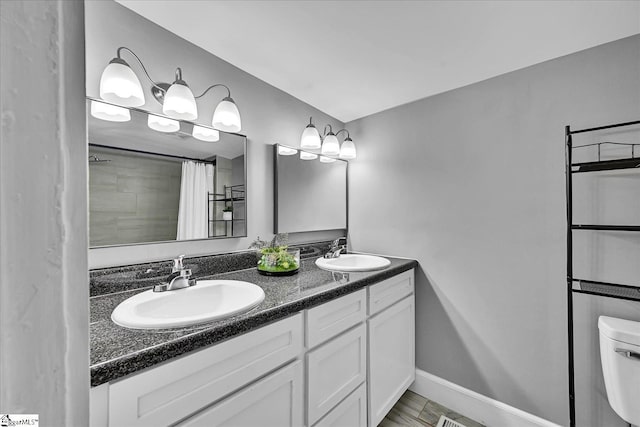 23 Stringer St, Belton, SC 29627 - bathroom with double vanity and a shower with shower curtain