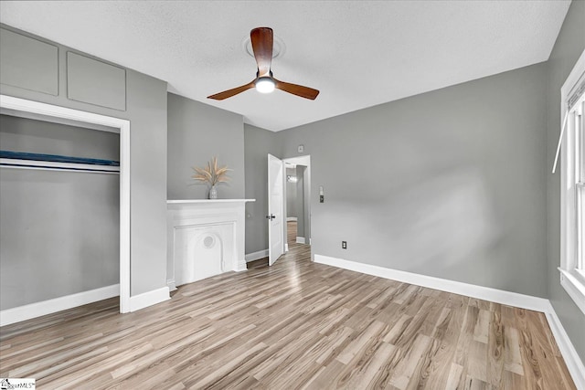 23 Stringer St, Belton, SC 29627 - unfurnished bedroom featuring light wood-style flooring, a closet, ceiling fan, and a textured ceiling