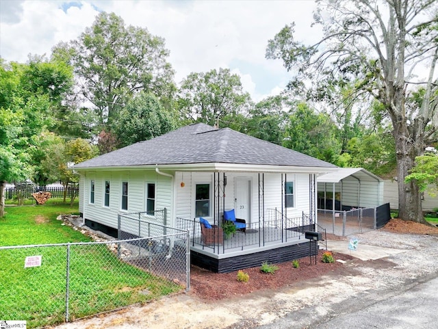 23 Stringer St, Belton, SC 29627 - view of front facade featuring a shingled roof, a porch, view of wooded area, and a detached carport