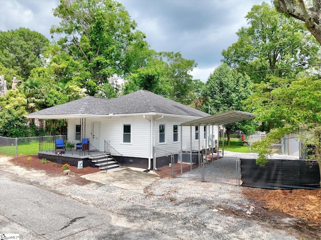 23 Stringer St, Belton, SC 29627 - view of front of home featuring a detached carport, a gate, roof with shingles, crawl space, and a porch