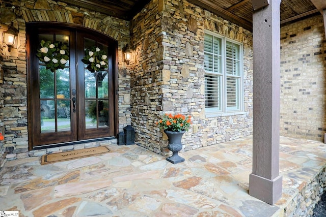 108 Ledgestone Way, Greer, SC 29651 - property entrance featuring french doors, stone siding, and covered porch