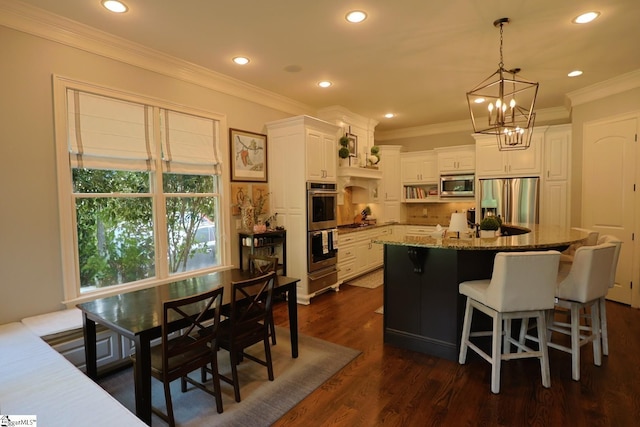108 Ledgestone Way, Greer, SC 29651 - kitchen featuring appliances with stainless steel finishes, a chandelier, stone countertops, ornamental molding, and white cabinetry