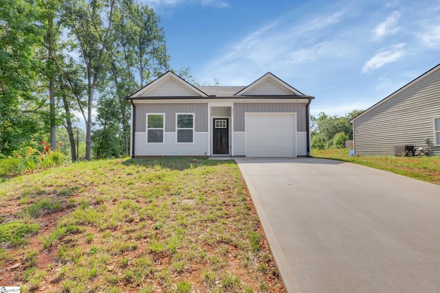 317 R C Thompson Rd, Chesnee, SC 29323 - single story home featuring board and batten siding, a garage, driveway, and a front yard