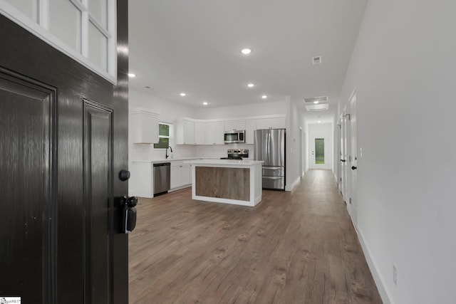 317 R C Thompson Rd, Chesnee, SC 29323 - kitchen featuring stainless steel appliances, white cabinets, light countertops, a center island, and wood finished floors