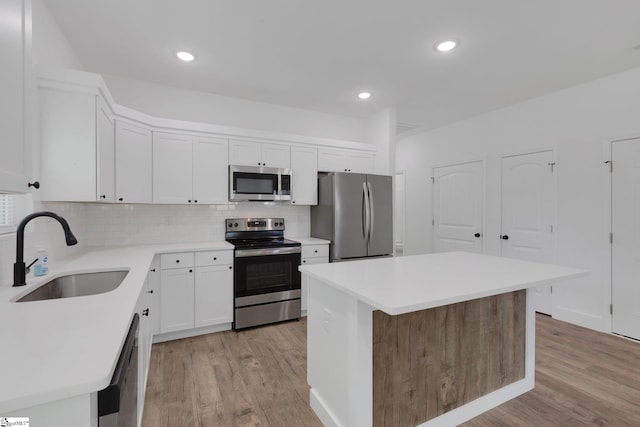 317 R C Thompson Rd, Chesnee, SC 29323 - kitchen with appliances with stainless steel finishes, light wood-style floors, backsplash, a center island, and recessed lighting