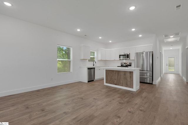 317 R C Thompson Rd, Chesnee, SC 29323 - kitchen with stainless steel appliances, a center island, light wood-type flooring, white cabinets, and recessed lighting