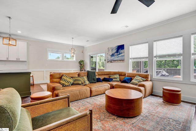 214 Terrapin Cross Way, Simpsonville, SC 29680 - living room with ornamental molding, ceiling fan, wood finished floors, a chandelier, and a wainscoted wall