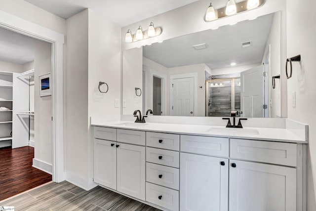 214 Terrapin Cross Way, Simpsonville, SC 29680 - bathroom with a shower stall, double vanity, and wood finished floors