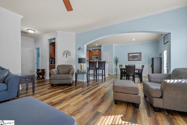114 Eagles View Ct, Easley, SC 29642 - living area with arched walkways, wood finished floors, ornamental molding, ceiling fan, and recessed lighting