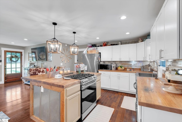 301 Ridgecrest Dr, Easley, SC 29640 - kitchen featuring appliances with stainless steel finishes, wood counters, backsplash, dark wood-type flooring, and white cabinetry
