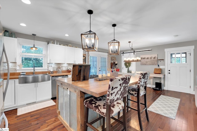 301 Ridgecrest Dr, Easley, SC 29640 - kitchen featuring dishwasher, butcher block counters, a breakfast bar, backsplash, and white cabinets