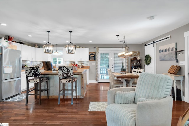 301 Ridgecrest Dr, Easley, SC 29640 - kitchen featuring freestanding refrigerator, butcher block countertops, a barn door, white cabinets, and backsplash
