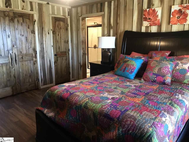 bedroom with dark hardwood / wood-style flooring