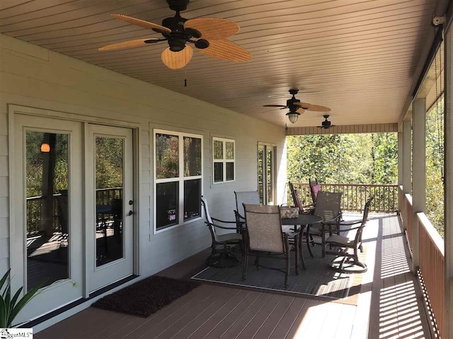 wooden terrace featuring french doors and ceiling fan