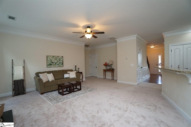 carpeted living room with ceiling fan and ornamental molding