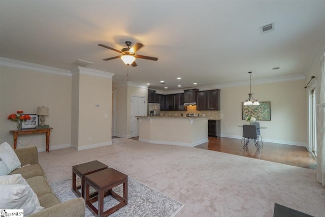 living room featuring ceiling fan, ornamental molding, and light carpet