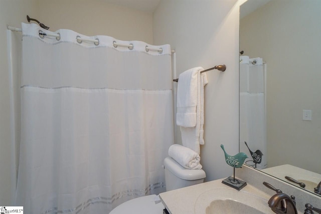 bathroom with toilet and vanity