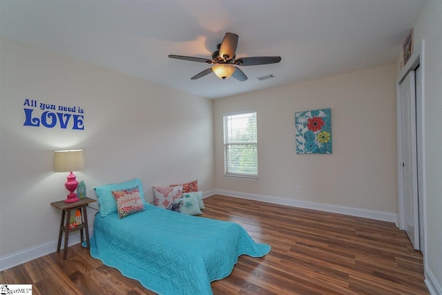 bedroom featuring a closet, ceiling fan, and dark hardwood / wood-style flooring