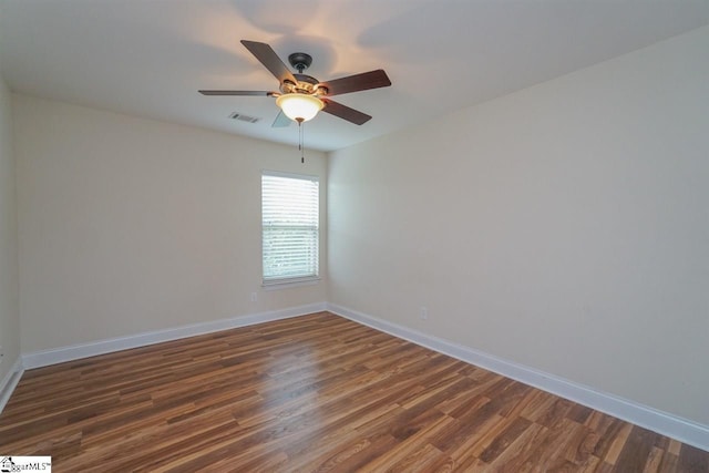 empty room with ceiling fan and dark wood-type flooring