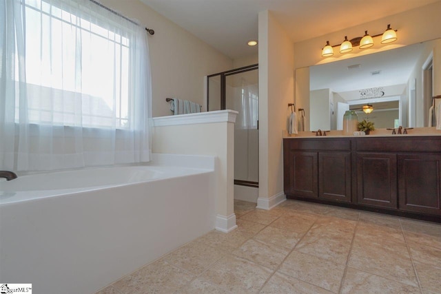 bathroom featuring dual sinks, large vanity, tile floors, and plus walk in shower