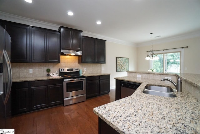 kitchen featuring light stone countertops, a notable chandelier, appliances with stainless steel finishes, sink, and an island with sink