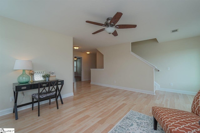 living area featuring light hardwood / wood-style flooring and ceiling fan