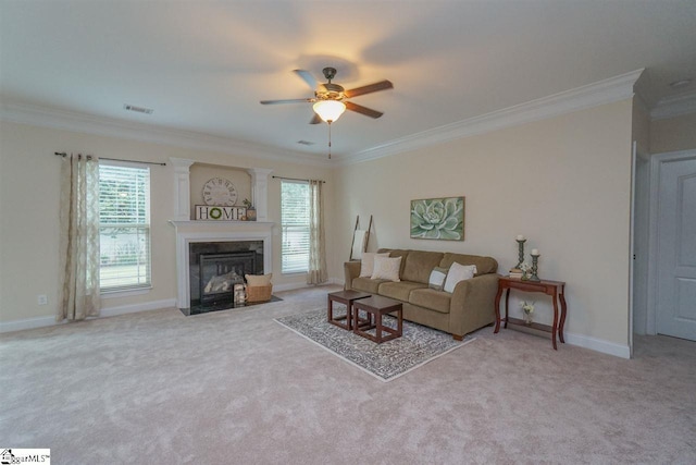 carpeted living room featuring a high end fireplace, crown molding, and ceiling fan