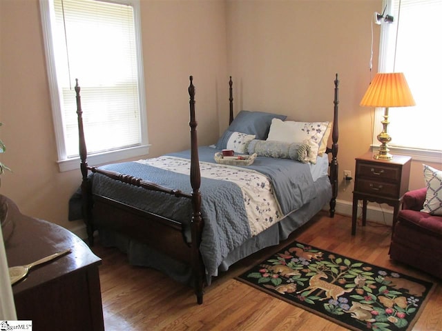 bedroom with hardwood / wood-style flooring