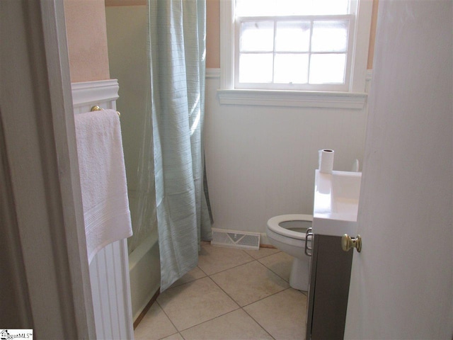 bathroom with tile flooring, shower / bath combination with curtain, and toilet